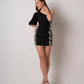  Black printed mini dress with side shell panel and puff sleeve, model in confident front pose.