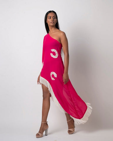 Model stands in side-facing pose showing off the sleek one-shoulder silhouette and high-low hem of the pink embroidered georgette dress