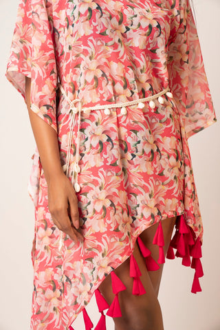 Close-up of tassel and shell details on pink printed georgette dress
