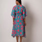 Rear view of the floral kaftan dress showing back silhouette, sleeve shape, and flared hem.