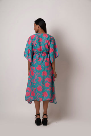 Rear view of the floral kaftan dress showing back silhouette, sleeve shape, and flared hem.