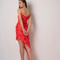 Back view of red floral high-low dress showing asymmetric hem and spaghetti straps.