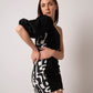 Black printed cotton mini dress with a one-shoulder neckline and asymmetrical design