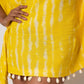 Close-up of yellow tie-dye dress waistline with lace detailing and seashell accents.