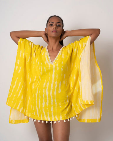 Yellow tie-dye cotton kaftan dress with lace and shell details, ideal for beach vacations and resort wear