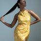 Side-angle standing pose of model flaunting lace-trimmed hemline and the dress’s contouring wrap style.