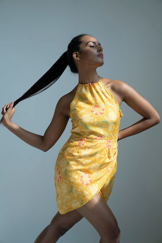 Yellow muslin dress with a halter neckline and sleeveless silhouette