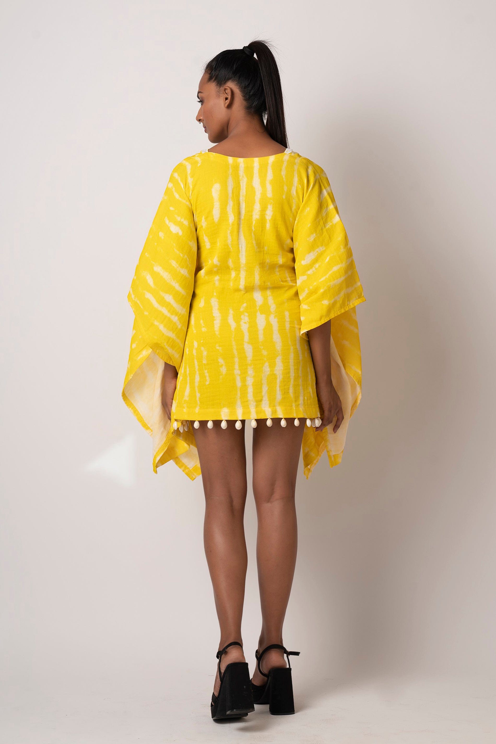 Back view of yellow tie-dye kimono dress showcasing relaxed fit and straight kaftan sleeves.